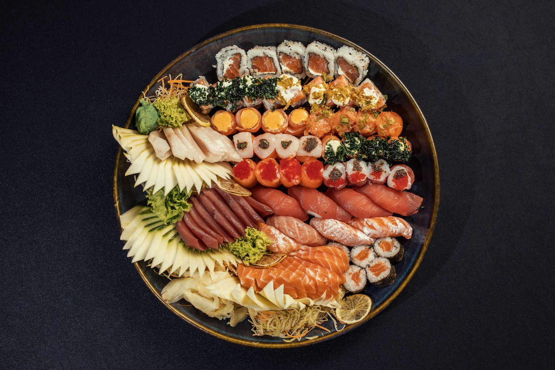 Assorted sushi platter on a dark surface